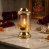 Brass_Akhand_Jyot_Diya_on_202607121306 Handcrafted Vintage Lantern Style Pure Brass Akhand Diya with Cylindrical Glass Chimney & Fluted Brass Crown Lid