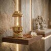 Brass_diya_on_walnut_shelf_202607121306 Handcrafted Vintage Lantern Style Pure Brass Akhand Diya with Cylindrical Glass Chimney & Fluted Brass Crown Lid