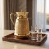 Brass_water_jug_on_tray_202607101017 Hira Craft Royal Paisley Engraved Pure Brass Water Pitcher with Brass Lid (1.5 Liters) – Royal Vintage Handle