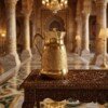 Brass_water_jug_on_wooden_202607101017 Hira Craft Royal Paisley Engraved Pure Brass Water Pitcher with Brass Lid (1.5 Liters) – Royal Vintage Handle