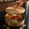 ChatGPT Image Jul 23, 2026, 10_48_16 PM Handcrafted Pure Brass Masala Dabba (Masaliyu) – Royal Spice Box Set with 7 Inner Cups, Engraved Lid & Brushed Matte Gold Finish