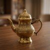 Handcrafted_brass_kettle_on_table_202607121053 Royal Handcrafted Pure Brass Tea Kettle (Teapot / Ketli) – Vintage Antique Finish with Floral Relief Engravings, Swan Spout & Pedestal Base