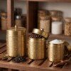 Three_brass_jars_neatly_arranged_202607232044 Luxury Handcrafted Pure Brass Kitchen Canister Jars (Set of 3 - Small, Medium, Large) – Matte Gold Finish with Traditional Geometric Relief Engravings & Ball Knob Lids